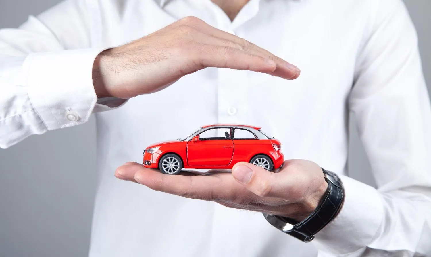 A small car resting in an open palm